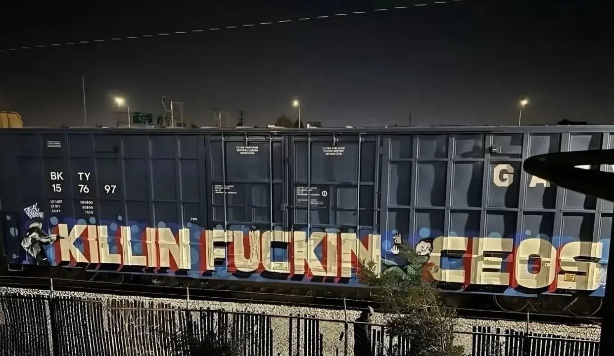 A freight train carriage with graffiti saying "Killin Fuckin CEOS"